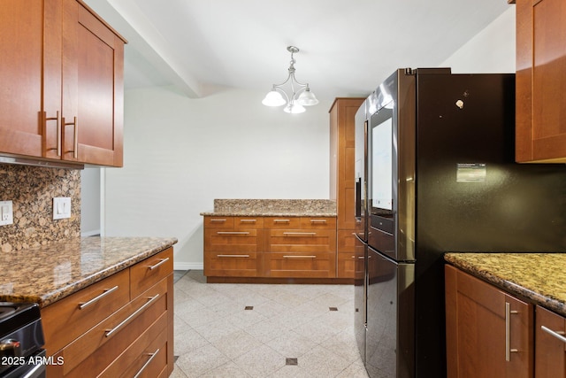 kitchen featuring appliances with stainless steel finishes, backsplash, light stone countertops, and granite tiled floors