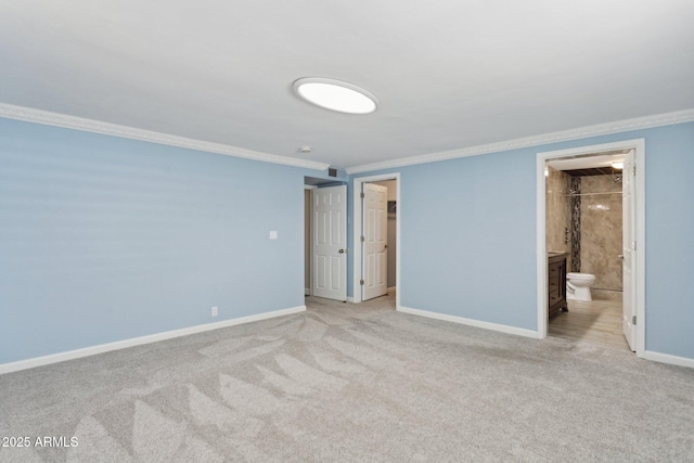 unfurnished bedroom featuring ornamental molding, carpet floors, baseboards, connected bathroom, and a spacious closet