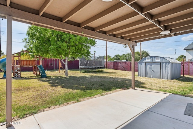 view of yard with a patio area, a trampoline, a storage shed, a playground, and an outdoor structure