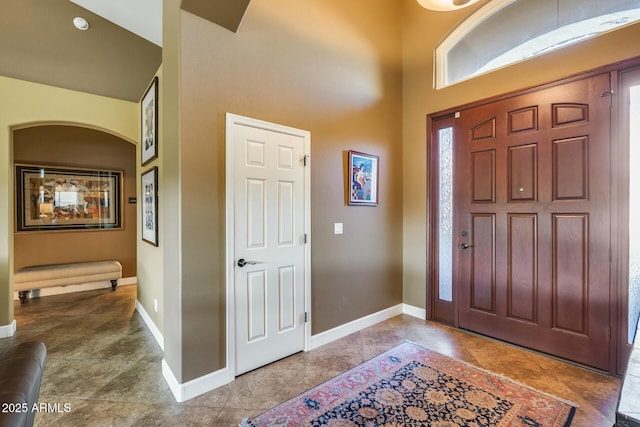 tiled foyer entrance with a high ceiling