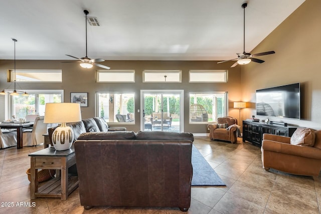 tiled living room with a towering ceiling and ceiling fan