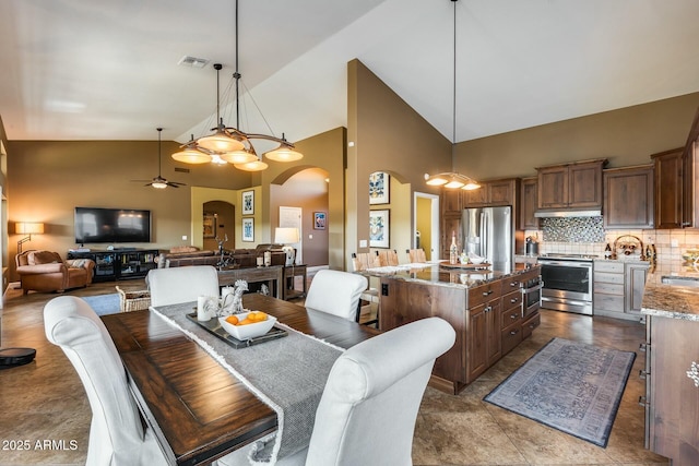 dining space featuring high vaulted ceiling and ceiling fan