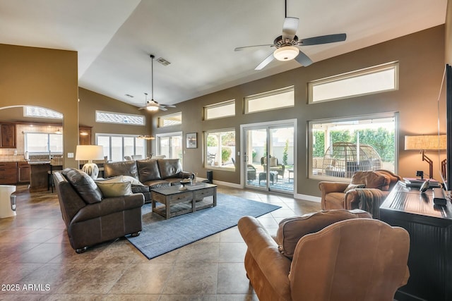 tiled living room featuring ceiling fan and high vaulted ceiling