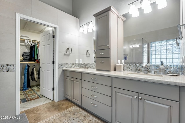 bathroom with vanity, backsplash, tile patterned flooring, and tile walls