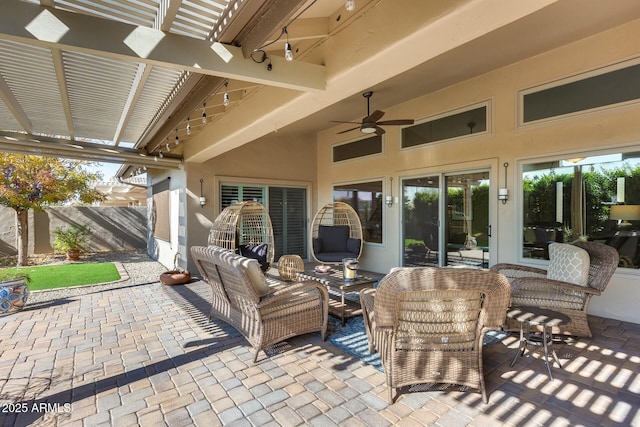 view of patio featuring an outdoor living space, ceiling fan, and a pergola