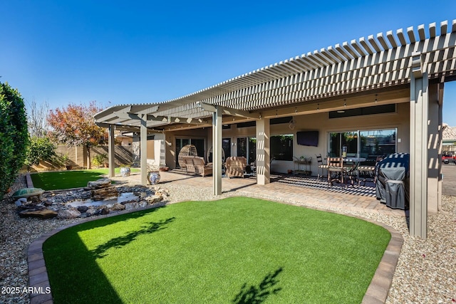 back of property with a yard, a pergola, and a patio