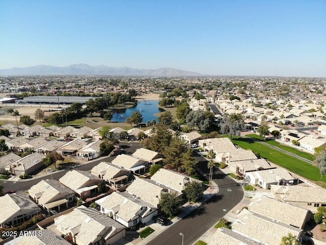 drone / aerial view featuring a water and mountain view