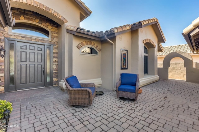 entrance to property featuring a patio area