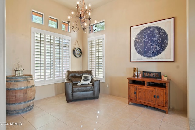 living area with light tile patterned floors and a chandelier