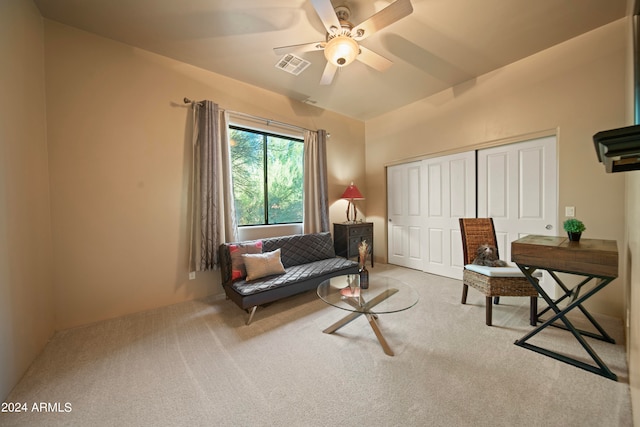 living area featuring ceiling fan and light carpet