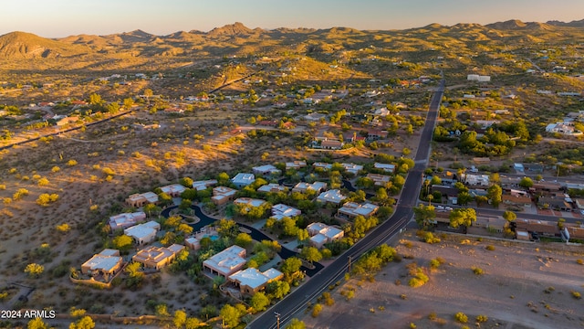 aerial view at dusk featuring a mountain view