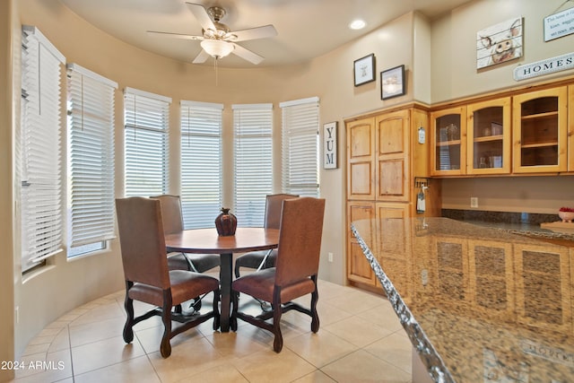 dining room with light tile patterned floors and ceiling fan