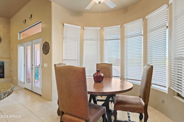 tiled dining space featuring ceiling fan, french doors, and a wealth of natural light