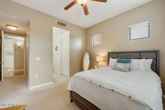 3330 S Gilbert Rd Unit 2090, Chandler, AZ 85286 - bedroom featuring light carpet, visible vents, a ceiling fan, and baseboards