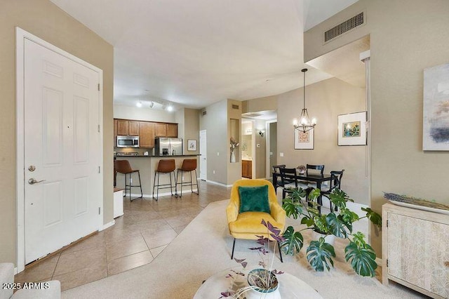 3330 S Gilbert Rd Unit 2090, Chandler, AZ 85286 - living room featuring light tile patterned floors, visible vents, baseboards, and a notable chandelier