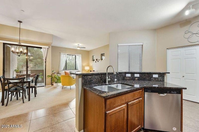 3330 S Gilbert Rd Unit 2090, Chandler, AZ 85286 - kitchen with brown cabinetry, a sink, stainless steel dishwasher, light colored carpet, and open floor plan