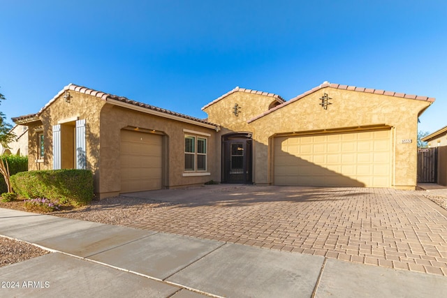 mediterranean / spanish home featuring a garage