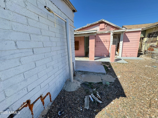 view of side of property with a patio