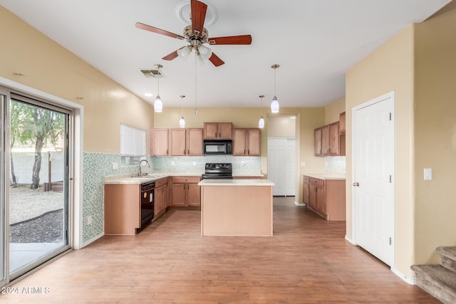 kitchen with pendant lighting, black appliances, light hardwood / wood-style floors, tasteful backsplash, and a kitchen island