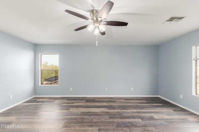 spare room with dark hardwood / wood-style flooring and ceiling fan