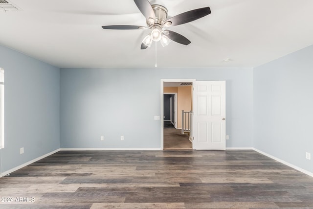 empty room with dark hardwood / wood-style floors and ceiling fan