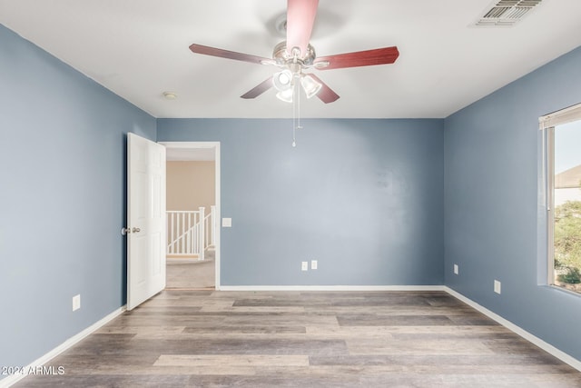 spare room with ceiling fan and light hardwood / wood-style flooring