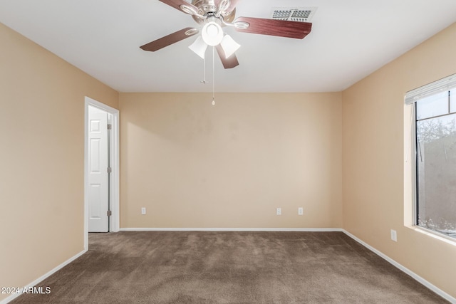 carpeted spare room with ceiling fan