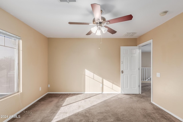 carpeted empty room featuring ceiling fan