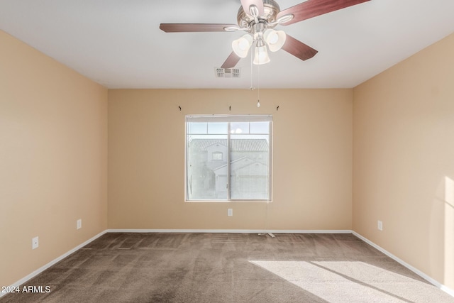 carpeted spare room with ceiling fan