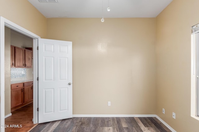 spare room with dark wood-type flooring