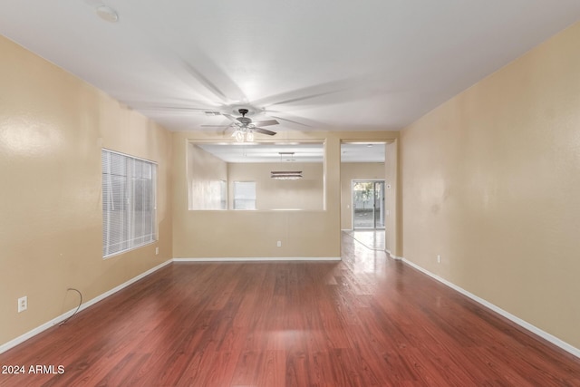 unfurnished room with ceiling fan and wood-type flooring