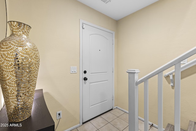 2111 N 77th Gln, Phoenix, AZ 85035 - entrance foyer featuring light tile patterned flooring, stairway, and baseboards