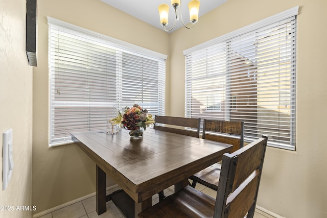 2111 N 77th Gln, Phoenix, AZ 85035 - dining space featuring a chandelier, baseboards, and tile patterned floors