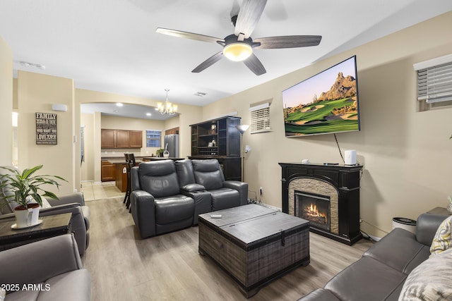 2111 N 77th Gln, Phoenix, AZ 85035 - living area with a chandelier, light wood finished floors, a ceiling fan, and baseboards