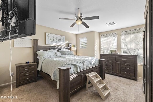2111 N 77th Gln, Phoenix, AZ 85035 - bedroom featuring light carpet, ceiling fan, and baseboards