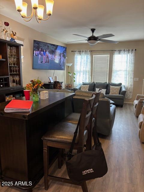 2111 N 77th Gln, Phoenix, AZ 85035 - dining area with wood finished floors, healthy amount of natural light, and a chandelier