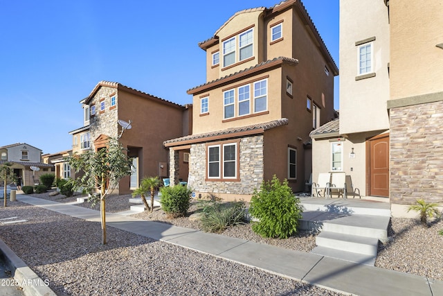 2111 N 77th Gln, Phoenix, AZ 85035 - view of front of house featuring a tiled roof, stone siding, stucco siding, and a residential view