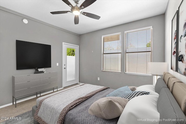 carpeted bedroom featuring ceiling fan, baseboards, and access to outside