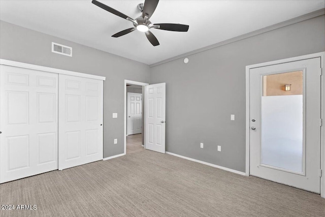 unfurnished bedroom with carpet floors, a closet, visible vents, a ceiling fan, and baseboards