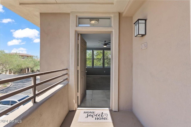 doorway to property featuring a balcony and stucco siding