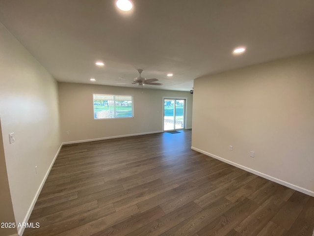 unfurnished room featuring dark wood-type flooring and ceiling fan