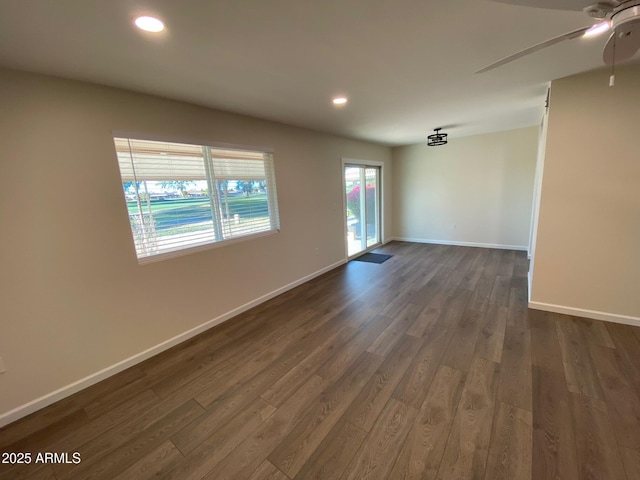 unfurnished room featuring ceiling fan and dark hardwood / wood-style flooring