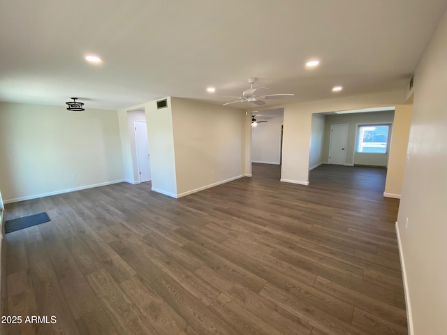 unfurnished living room with ceiling fan and dark hardwood / wood-style flooring