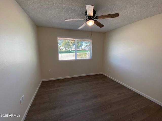 spare room with dark wood-type flooring, a textured ceiling, and ceiling fan