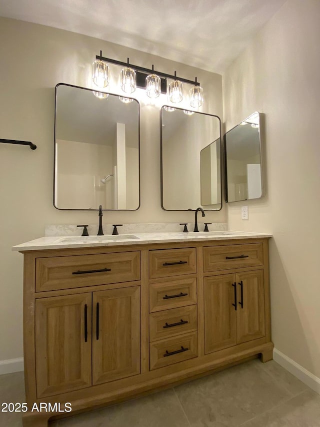 bathroom featuring tile patterned flooring and vanity