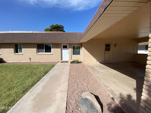 view of front of property with a carport and a front lawn