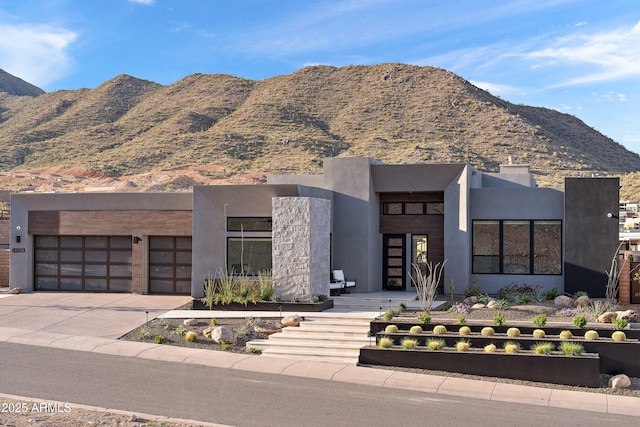 14108 E Harmony Ln, Fountain Hills, AZ 85268 - contemporary house featuring a garage, driveway, stucco siding, and a mountain view