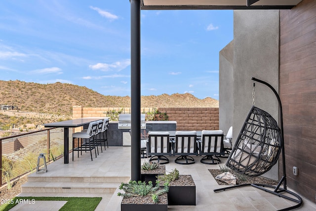14108 E Harmony Ln, Fountain Hills, AZ 85268 - view of patio with outdoor dry bar, fence, a grill, exterior kitchen, and a mountain view