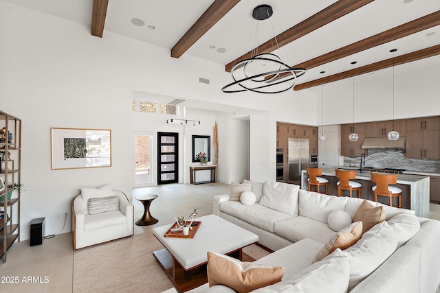 14108 E Harmony Ln, Fountain Hills, AZ 85268 - living room with light tile patterned floors, a high ceiling, beam ceiling, visible vents, and a notable chandelier