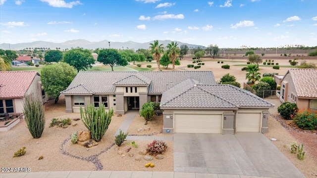 view of front of home with a garage and a mountain view